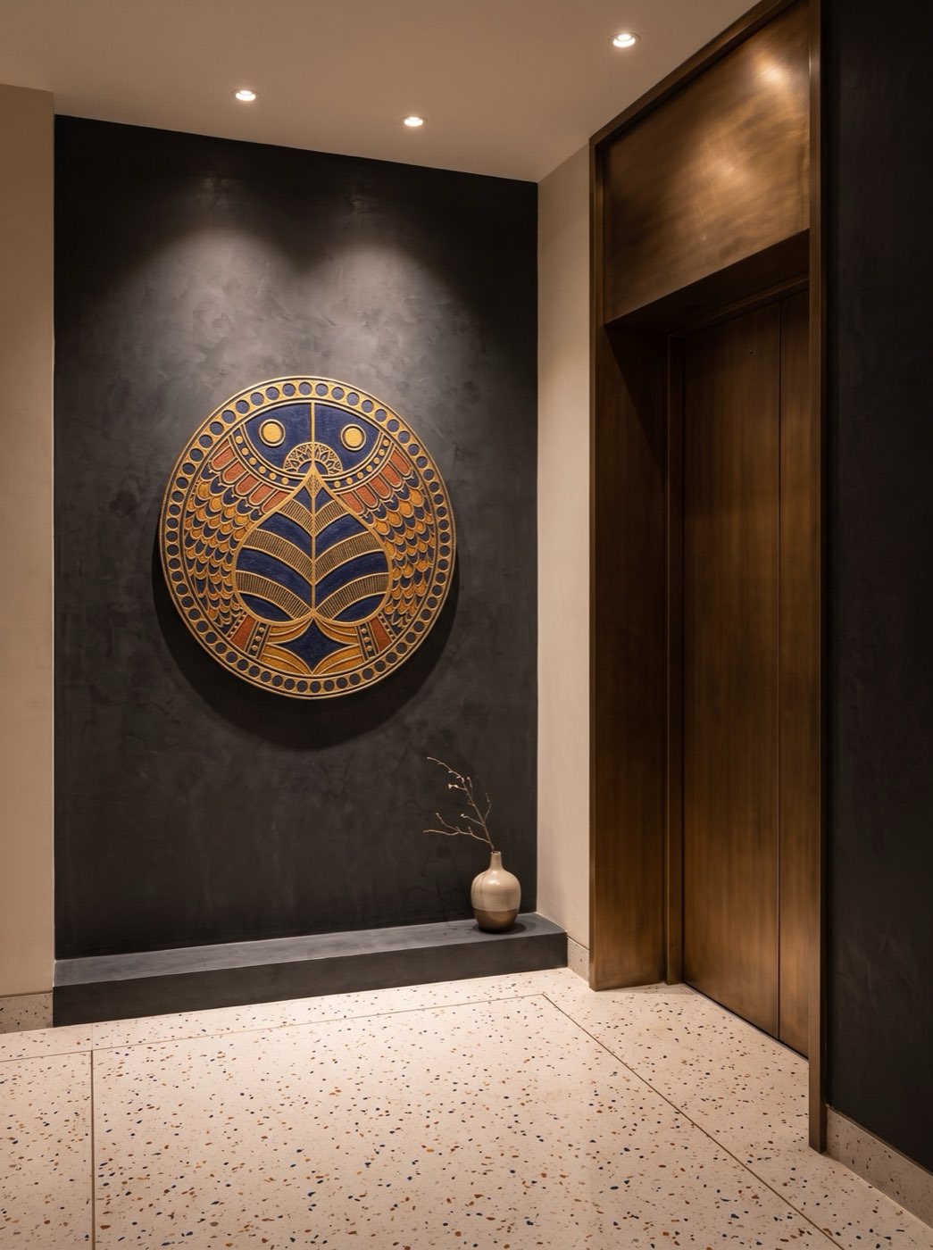 Colorized architectural relief panel turning a luxury hotel elevator landing into an art-led moment of pause.