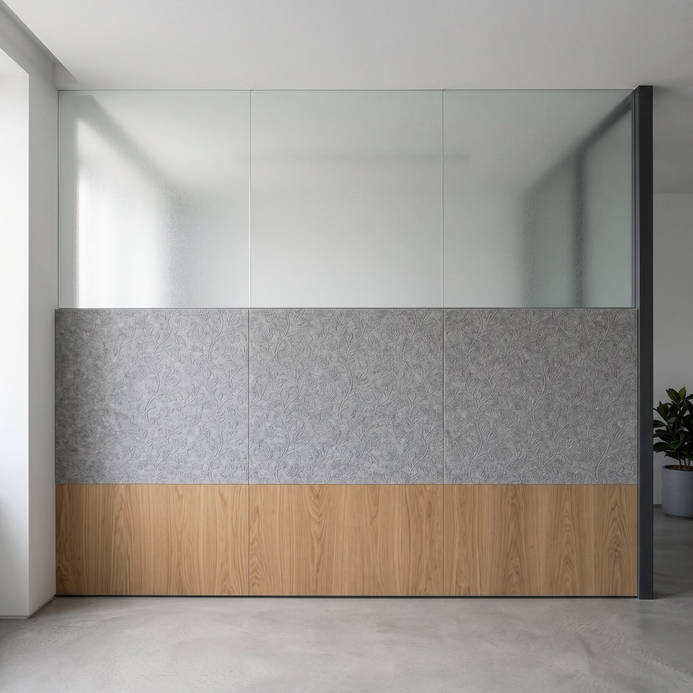 A deeply etched Kalamkari botanical masterwork on charcoal acoustic felt panels forming a C-suite office partition.