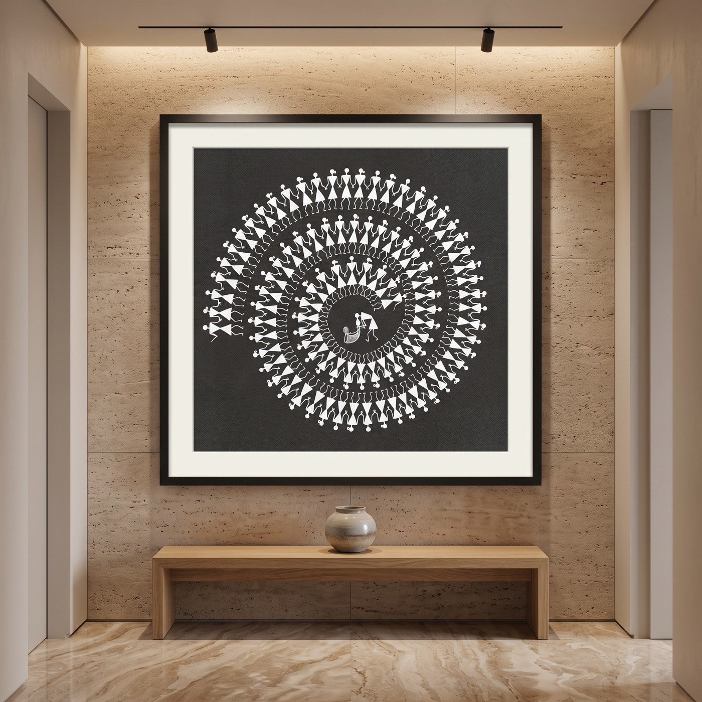 Oversized framed Warli Tarpa dance masterwork, white figures spiralling on a charcoal ground, hung above an oak bench on a travertine gallery threshold wall.