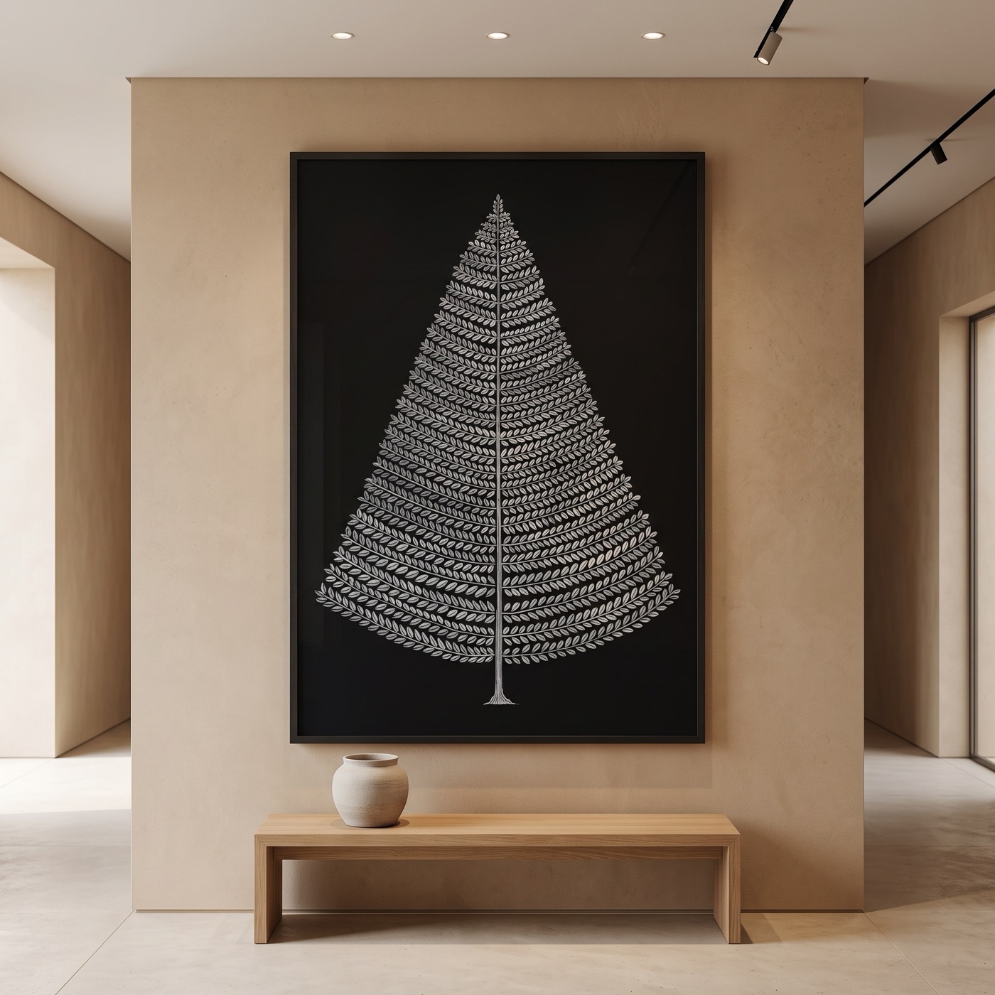 A vertical framed Pattachitra Tree of Life, silver-white leaves in tiered rows on near-black, hung on a warm plaster wall above a light oak bench.